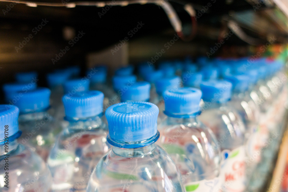 plastic bottles with water, caps plastic bottles with water, caps