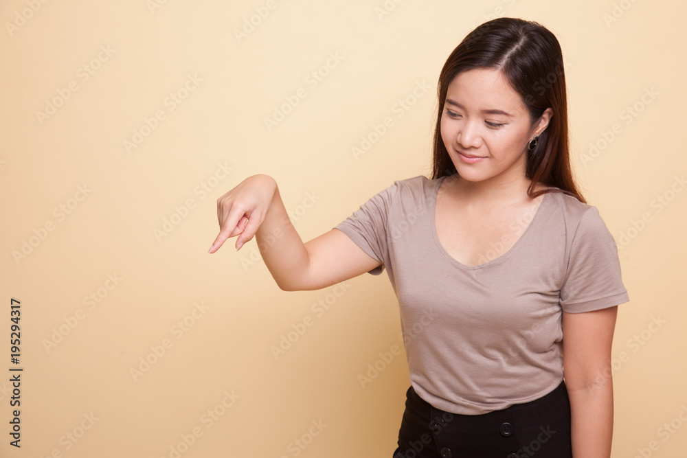 Beautiful young Asian woman point down to blank space. Beautiful young Asian woman point down to blank space.