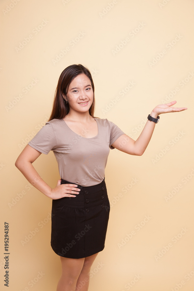Young Asian woman present with her hand. Young Asian woman present with her hand.