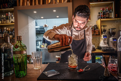Male bartender is making cocktail