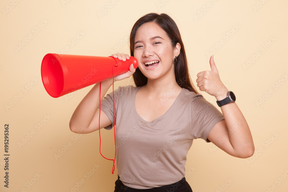 Beautiful young Asian woman show thumbs up announce with megaphone. Beautiful young Asian woman show thumbs up announce with megaphone.