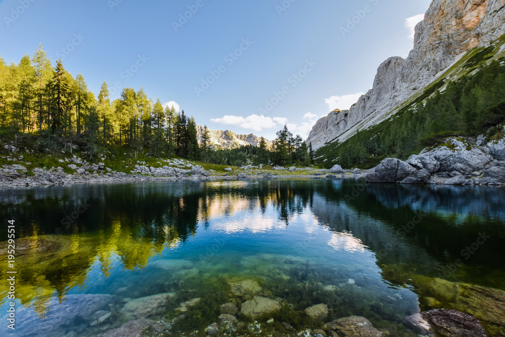 Stunning early morning view of Double Lake (Dvojno jezero) and Triglav Lakes Lodge (Koča pri Triglavskih jezerih) in the background, located in Triglav National Park in the Julian Alps,  Slovenia.