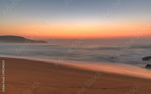 Hazy Sunrise Seascape with Rocks © Merrillie