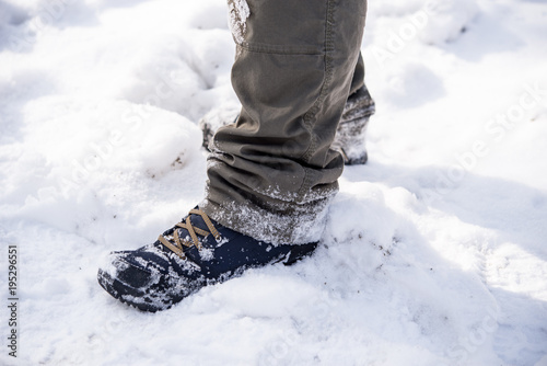 Man walking in winter snow - leg perspective