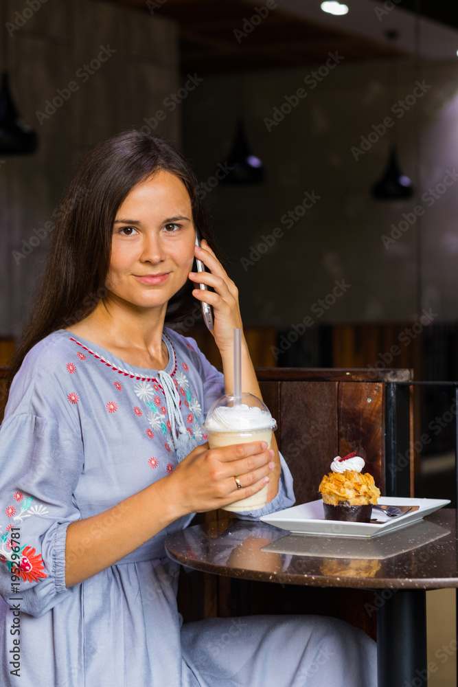 Woman talking with friends by mobile phone in cafe Woman talking with friends by mobile phone in cafe