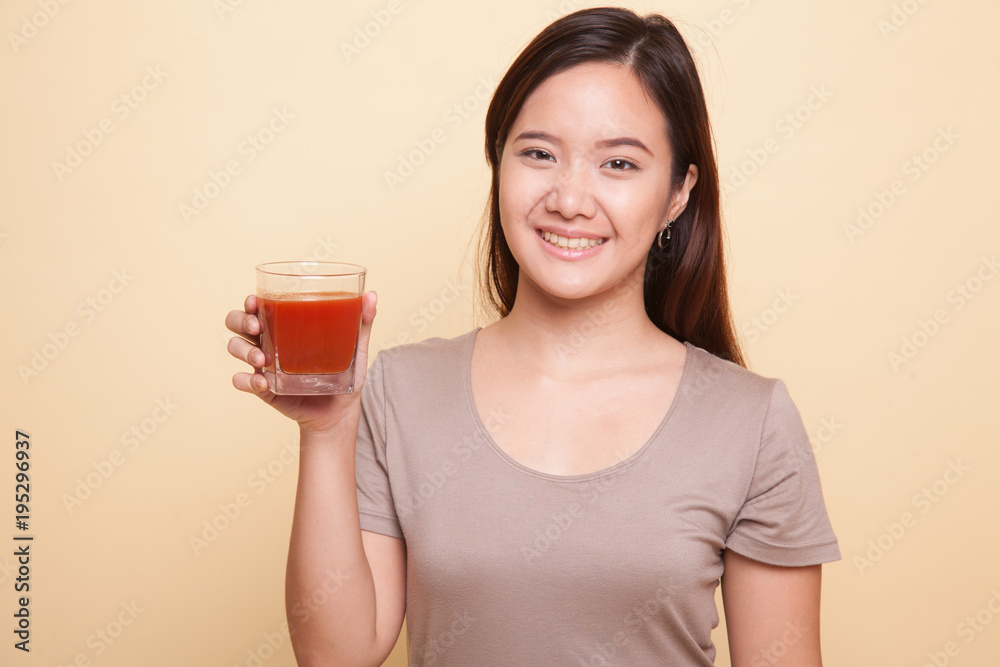 Young Asian woman drink tomato juice. Young Asian woman drink tomato juice.
