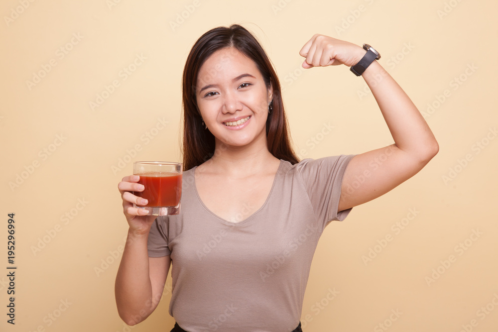 Strong healthy Asian woman with tomato juice. Strong healthy Asian woman with tomato juice.