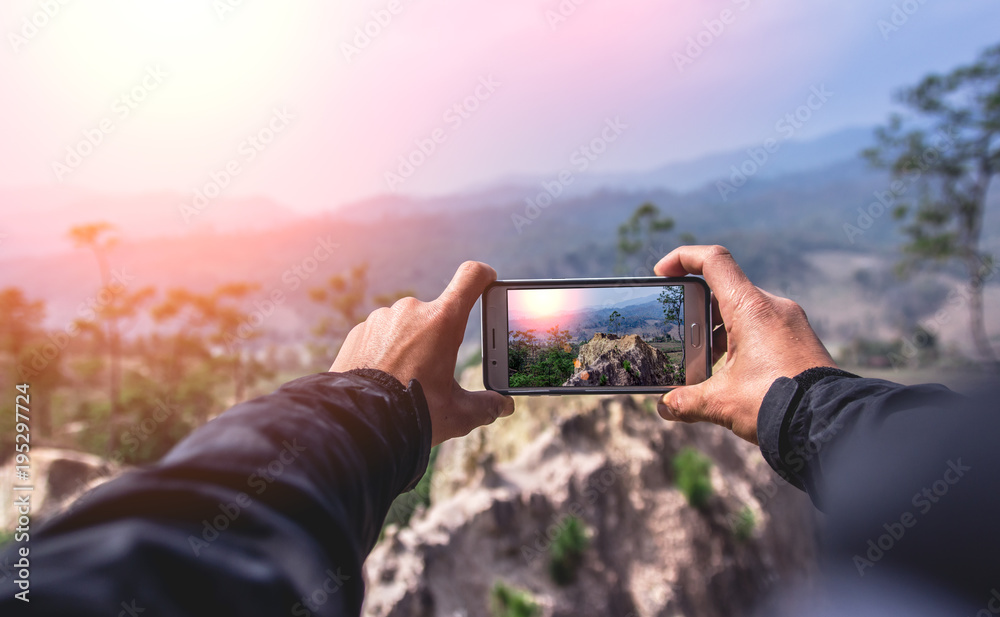 Man using smart phone take a photo mountain view - obrazy, fototapety, plakaty 