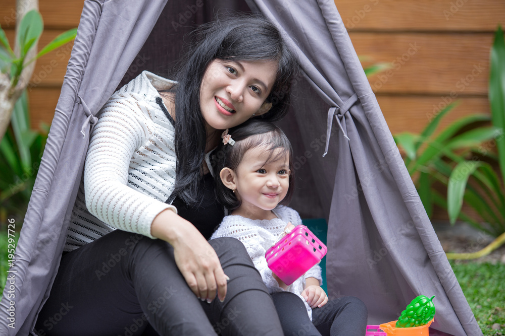 play toys with mother in tent