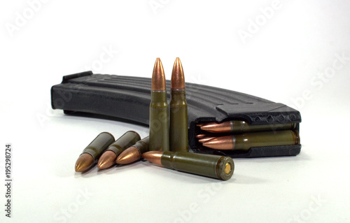 cartridges for a Kalashnikov assault rifle in a horn and loose, close-up