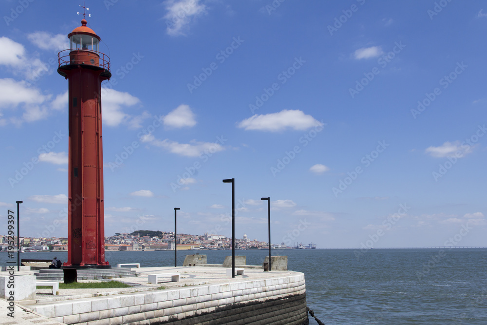 Red lighthouse on the waterfront in Almada, Portugal