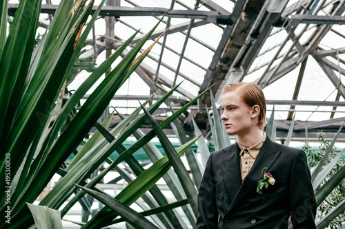 portrait of fashionable young red hair man in glasshouse © LIGHTFIELD STUDIOS