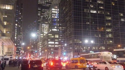 Traffic In City At Red Light Near Buildings - Pan - Right To Left
