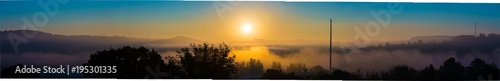 Cloudscape panorama of sunrise over forest
