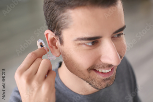 Young man putting hearing a...