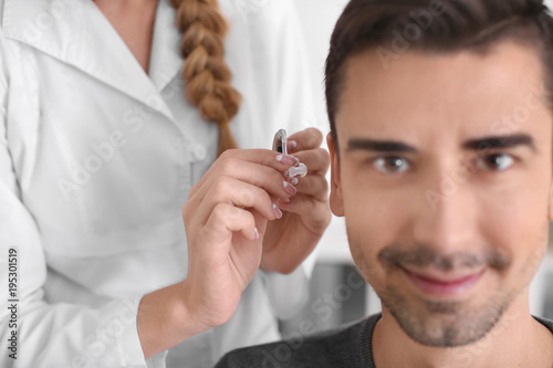 Otolaryngologist putting he...