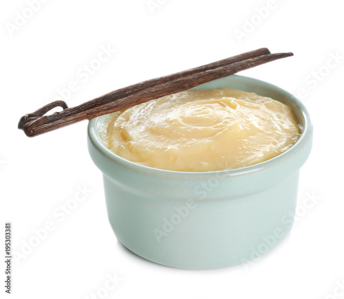 Fotografering Tasty vanilla pudding in ramekin and sticks on white background