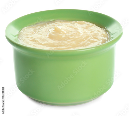 Tasty vanilla pudding in ramekin on white background