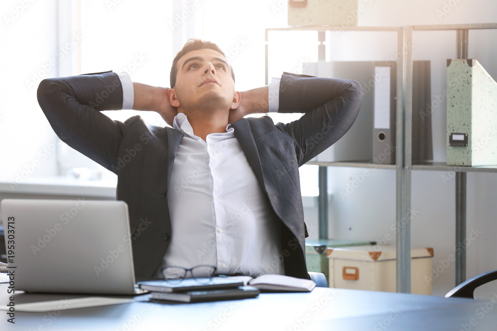 Young man in office resting at workplace Young man in office resting at workplace