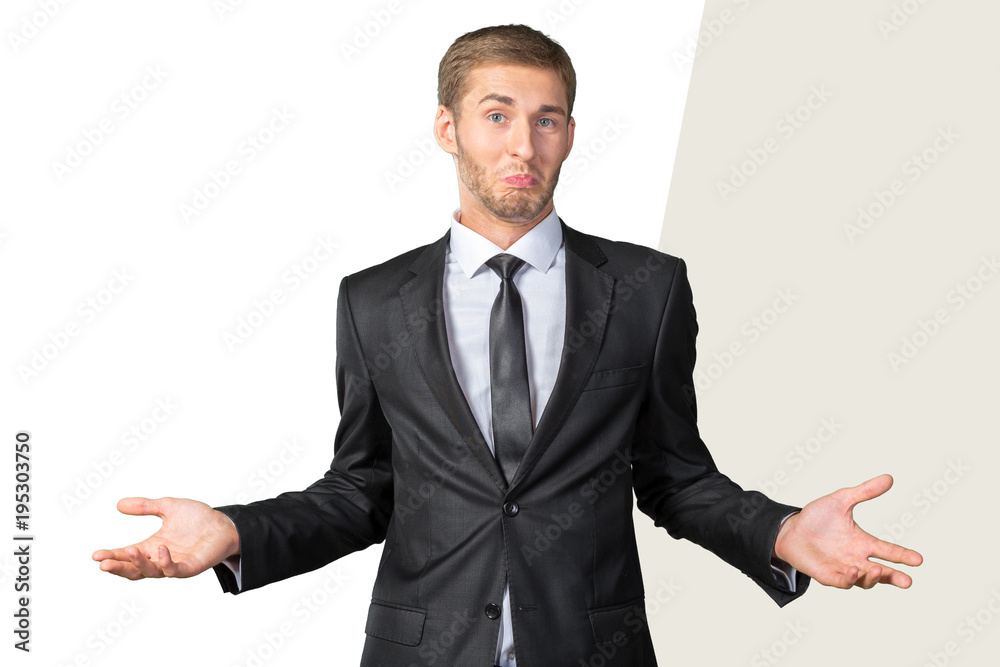 Young handsome man gesturing ‘I don’t know’ Young handsome man gesturing ‘I don’t know’