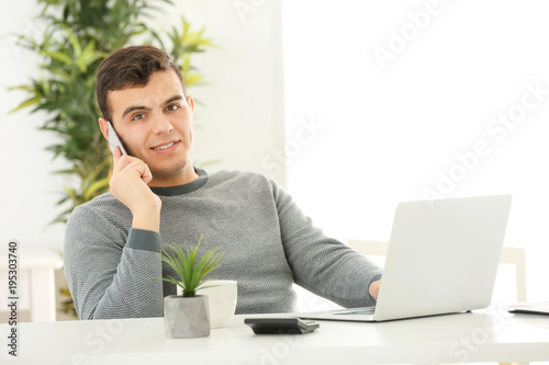 Young man talking on phone ...