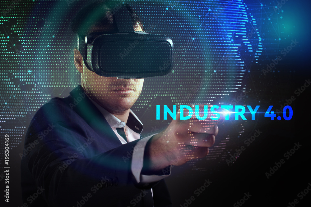 Business, Technology, Internet and network concept. Young businessman working in virtual reality glasses sees the inscription: Industry 4.0 Business, Technology, Internet and network concept. Young businessman working in virtual reality glasses sees the inscription: Industry 4.0