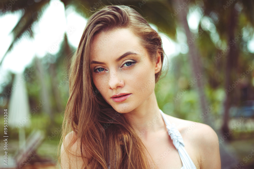Portrait of young woman with long hair looking at camera Portrait of young woman with long hair looking at camera
