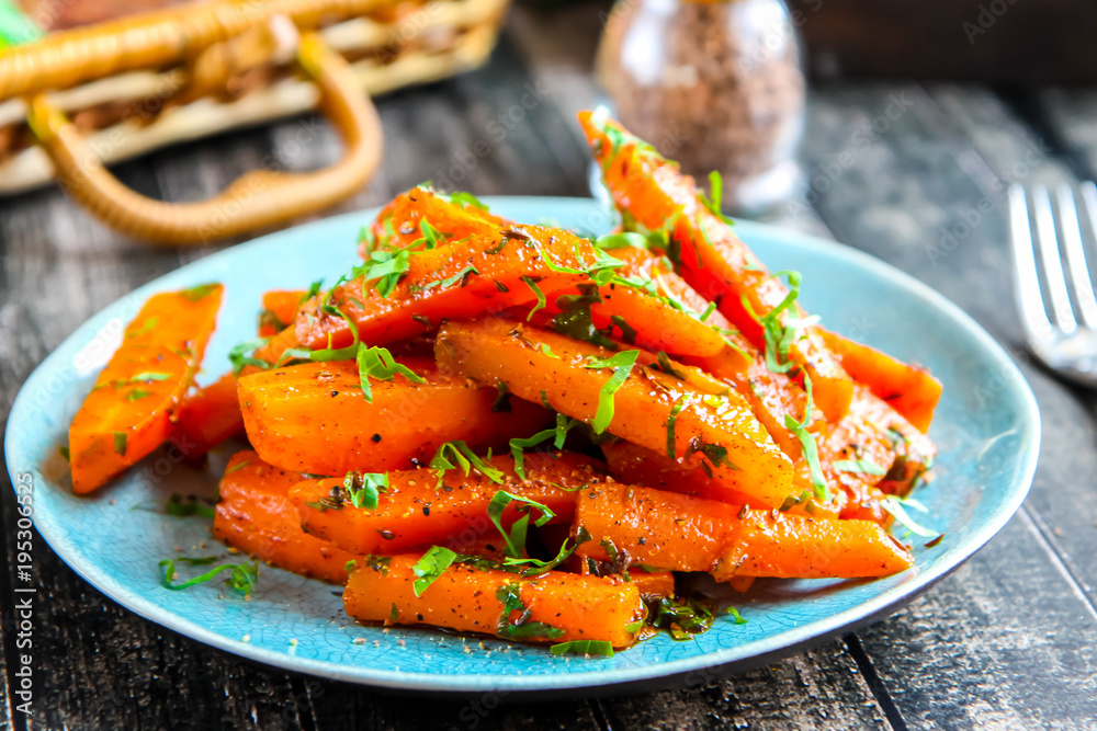 Carrots with spices and greens on a turquoise plate Carrots with spices and greens on a turquoise plate