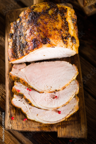 Roasted pork loin on the old wooden table