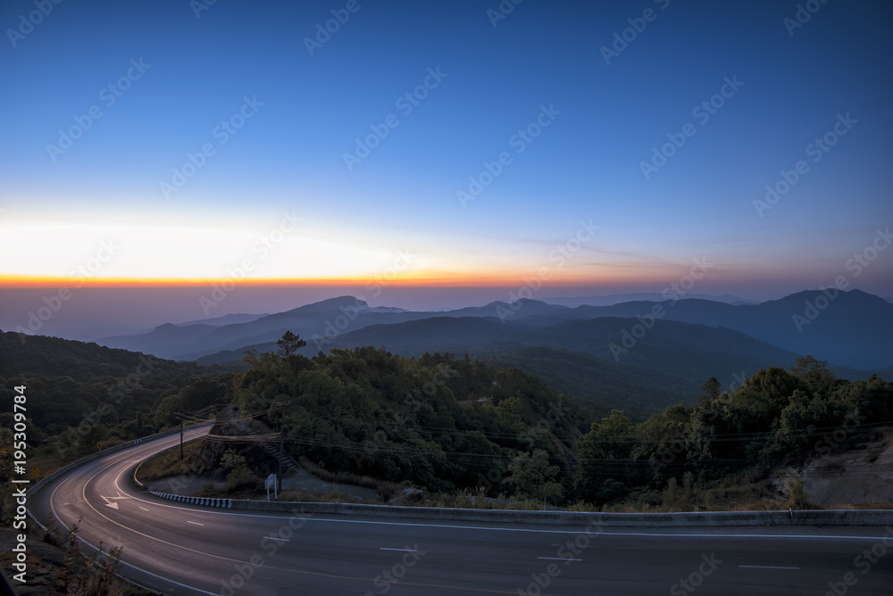 The road in the mountain forest way to on top mountain at Doi Inthanon National park in the sunrise time at Chiang Mai, Thailand.