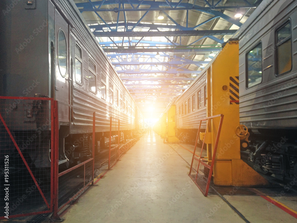 Fototapeta premium Passenger cars wagoon locomotive on repair in depots of railways, hangar view.