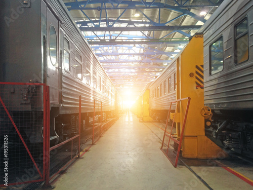 Passenger cars wagoon locomotive on repair in depots of railways, hangar view. photo