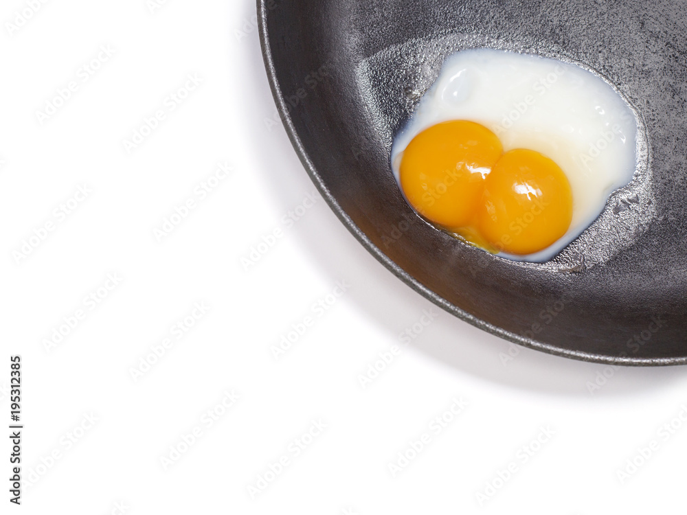 White background with egg in a frying pan White background with egg in a frying pan