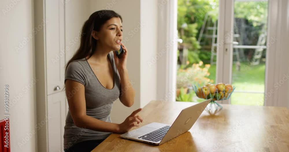 4K Professional woman with laptop dealing with business problems over the phone. Slow motion.
