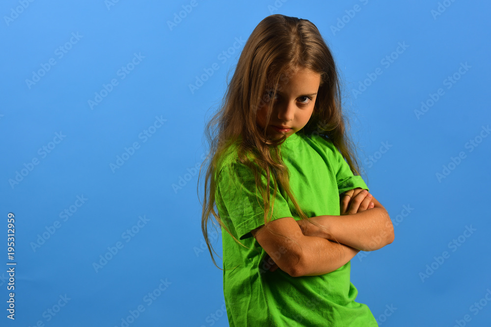 Girl with arrogant and grumpy face on blue background Girl with arrogant and grumpy face on blue background