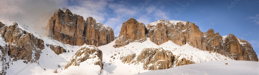 Panoramic landscape of the Sass Pordoi group in the Italian dolomites, as seen from Pass Pordoi. Canazei, Trento. Italy. Panoramic landscape of the Sass Pordoi group in the Italian dolomites, as seen from Pass Pordoi. Canazei, Trento. Italy.