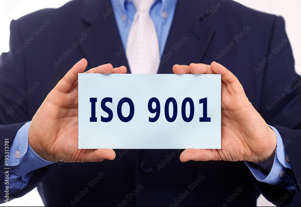 Business man hold paper ISO 9001 text on it Business man hold paper ISO 9001 text on it
