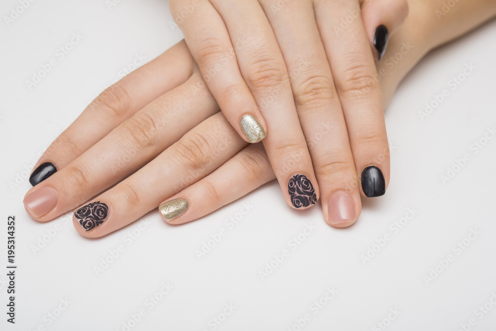 Caviar manicure in yellow black nails with black and gold rhinestones on a yellow background. Caviar manicure in yellow black nails with black and gold rhinestones on a yellow background.