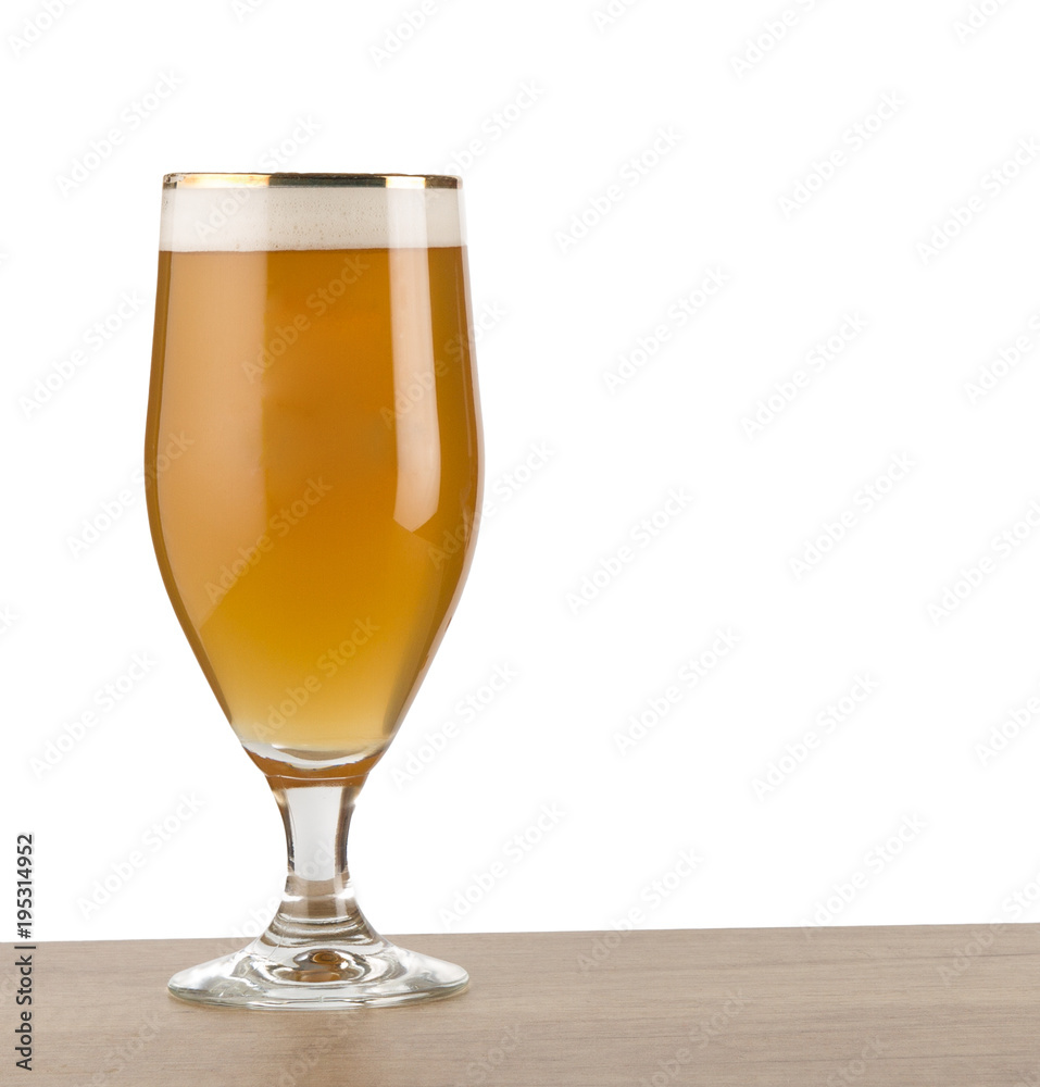 Craft beer in glass on wooden table isolated on white