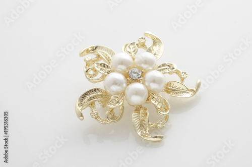 gold brooch flower with pearl isolated on white