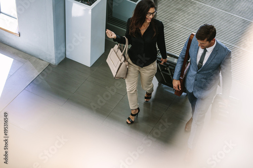 Business people arriving at hotel with luggage photo