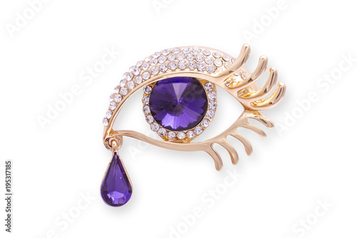 Gold brooch eye with diamonds isolated on white photo