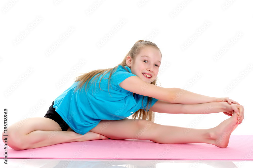 The little gymnast perform an acrobatic element on the floor. The little gymnast perform an acrobatic element on the floor.