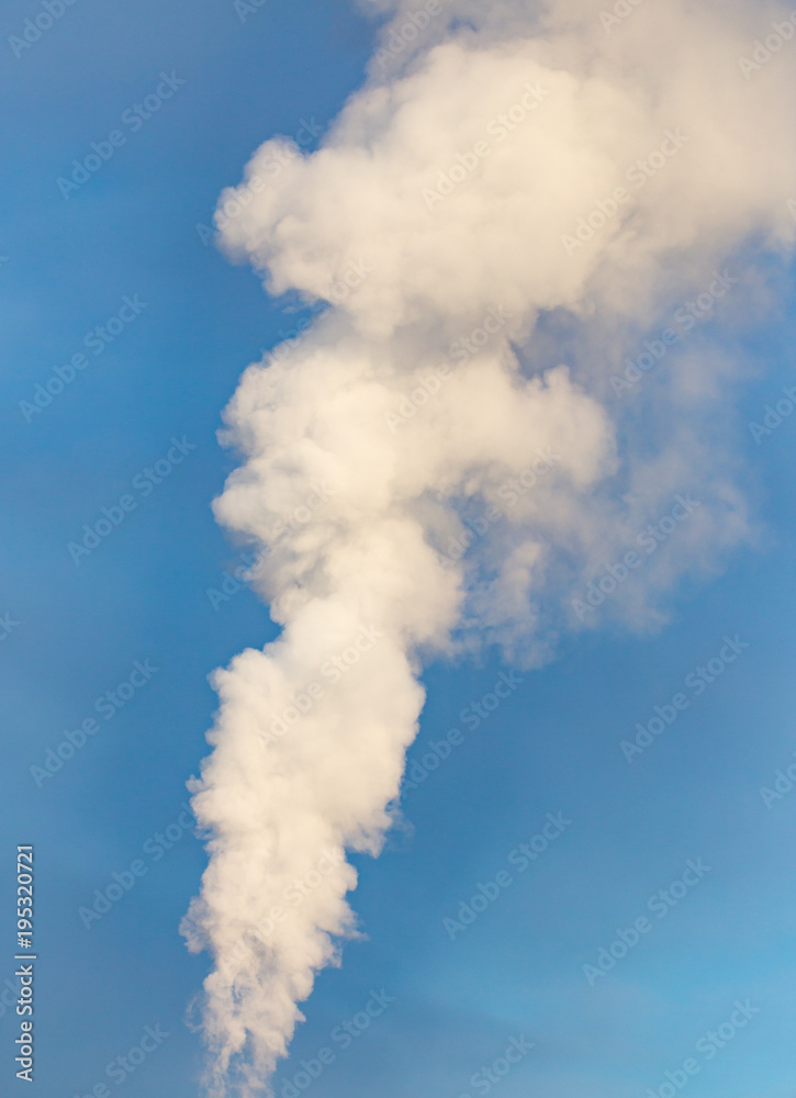 smoke from a pipe in the factory against a blue sky smoke from a pipe in the factory against a blue sky