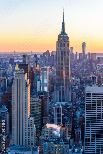 New York City - USA. View to Lower Manhattan downtown skyline with famous Empire State Building and One World Center and skyscrapers at sunset. © Simon Dannhauer