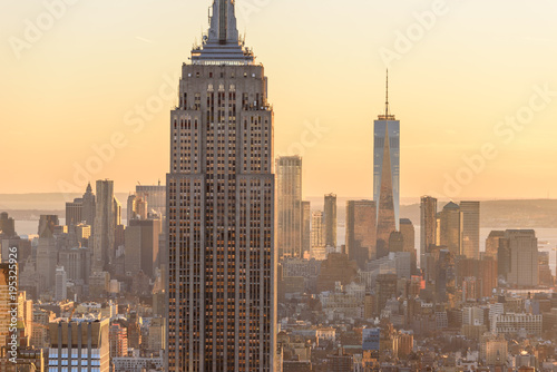 New York City - USA. View to Lower Manhattan downtown skyline with famous Empire State Building and One World Center and skyscrapers at sunset. © Simon Dannhauer