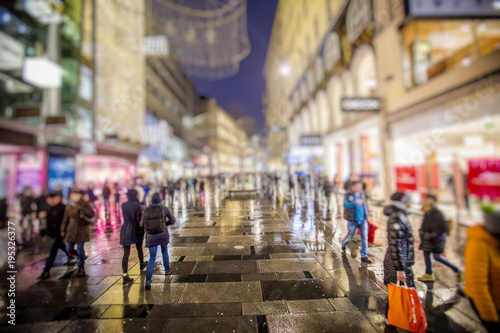 people walking on rainy night streets in vienna © babaroga