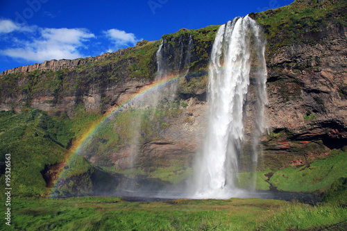Rainbow and waterfall Seljalandsfoss in Iceland