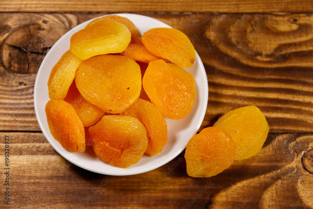 Dried apricots on wooden table