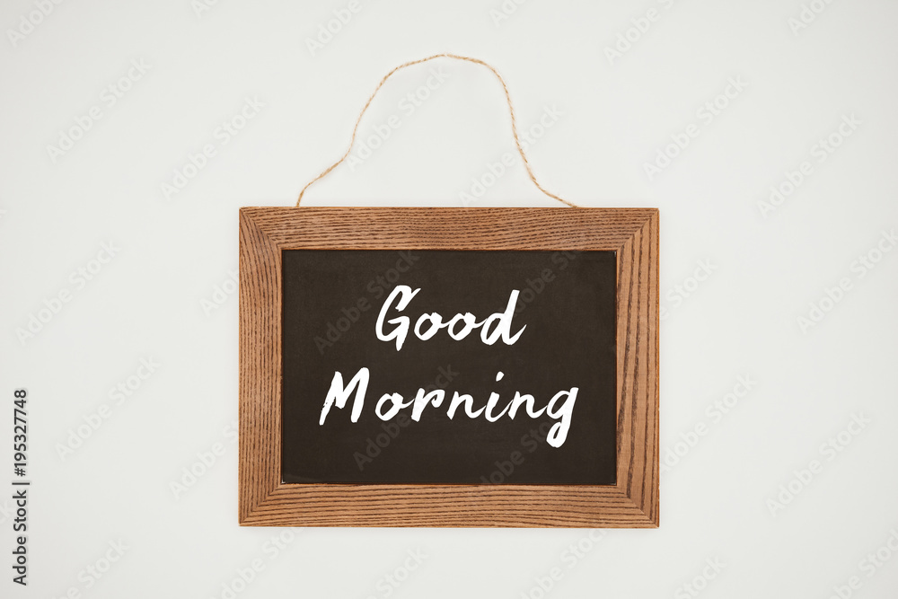 Fototapeta premium good morning lettering on chalkboard with wooden frame and thread isolated on white